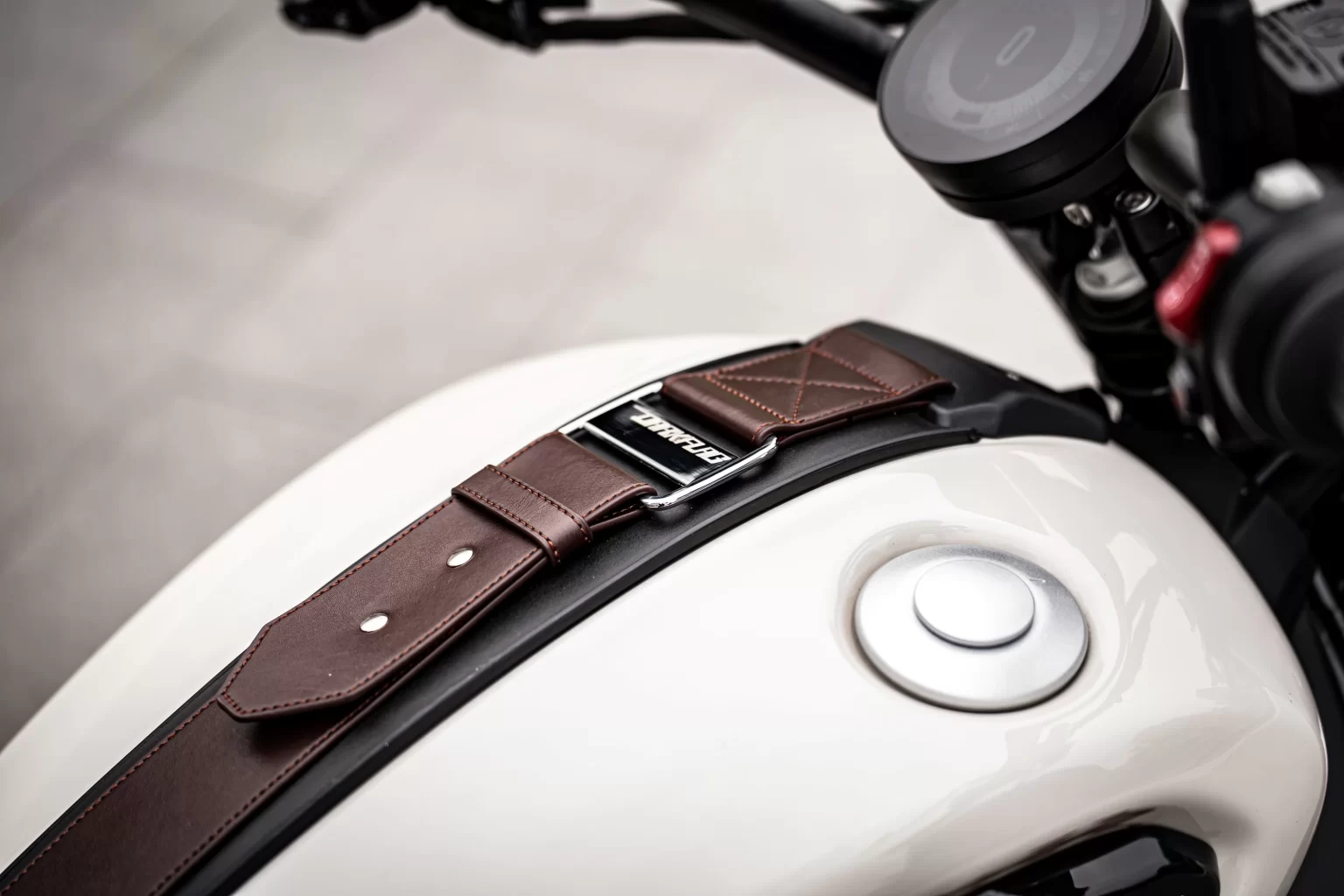 Brown leather tank strap and badge on the Benda Dark Flag 950